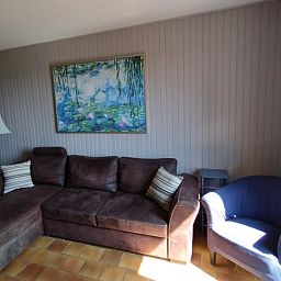 Cozy living room in Holiday Home in Lanty, Burgundy, France with comfortable sofas and art on the wall.