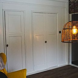 Modern living room in Holiday Home in Garyp, Friesland, with stylish lighting and seating area.