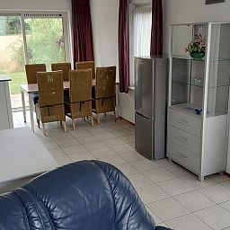 Gezellige eetkamer in Villa Zeerob, Scharendijke, vakantiehuis in Zeeland met uitzicht op de tuin.
