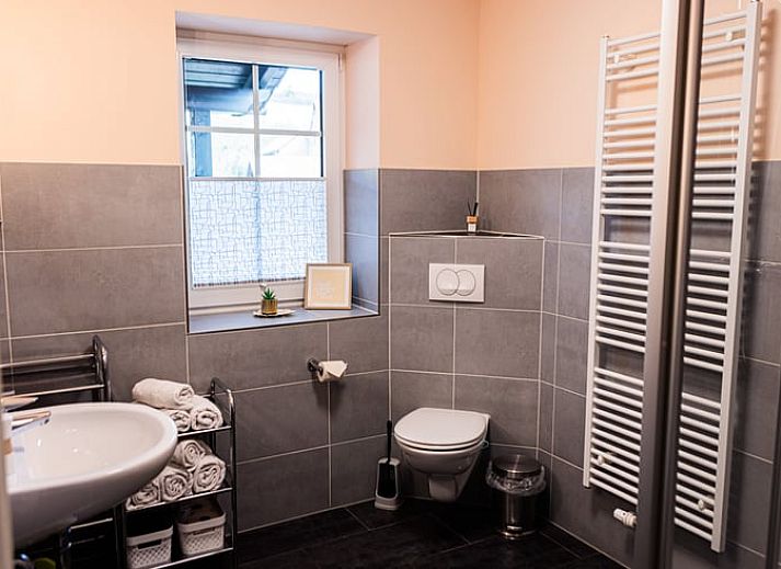 Gezellige woonkamer in Huisje in Rudolstadt, vakantiehuis in Thuringen, Duitsland met moderne inrichting en houten meubels.