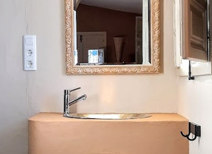 Sfeervolle slaapkamer in Vakantiehuis in Sedella, Andalusie, Spanje met warme tinten en comfortabele inrichting.