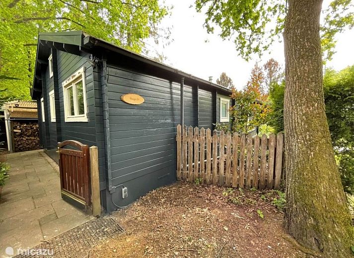 Charming bungalow Cottage 54 in Wateren, Drenthe, surrounded by green nature and an inviting terrace.