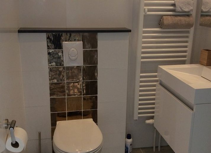 Cozy terrace with parasol at Tiny House Bakkum, vacation home in Castricum, North Sea coast, North Holland.