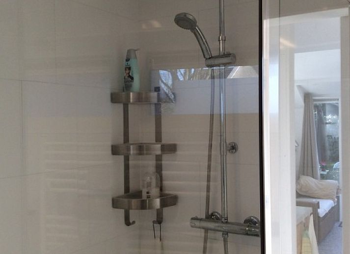 Cozy terrace with parasol at Tiny House Bakkum, vacation home in Castricum, North Sea coast, North Holland.