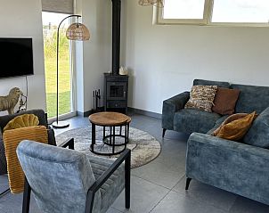 Cozy living room of Wulpenweid 12 A Lammetje, vacation home in De Dennen, Texel with modern furnishings.