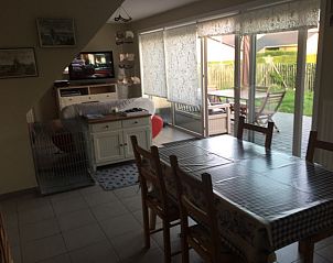 Ruime eetkamer in Zee en Polder vakantiehuis, Westende, Belgische kust, met uitzicht op de tuin.