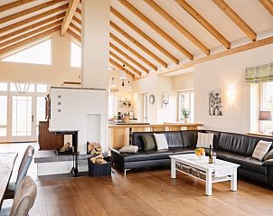 Cozy living room of Holiday Home in Soltau, Lower Saxony, with wooden beamed ceiling and spacious seating area.