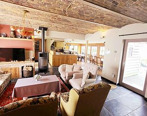 Cozy living room of Pladutse Gite vacation home in Kluisbergen, East Flanders, with wood stove.