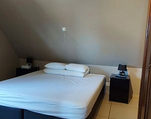 Cozy bedroom in vacation home At Wendy in Kluisbergen with comfortable double bed.