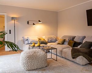 Cozy living room in Cottage in Kall, Eifel. Comfortable sitting area for relaxation in this vacation home in Germany.