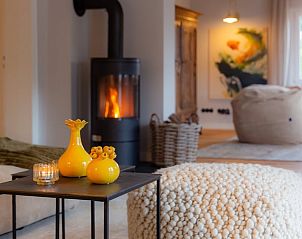 Cozy living room of Cottage in Kall, Eifel, with warm wood stove and cozy furnishings for ultimate comfort.