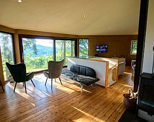 Bright living room in Holiday Home in Rodder, Eifel with panoramic views of nature.