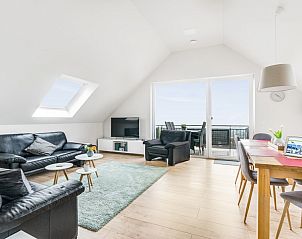 Bright living room of Ferienwohnung Panoramablick in Nickenich, Eifel, with nature views and modern furnishings.