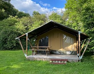 Safaritent in Utscheid, Rijnland-Palts, Duitsland met een uitnodigend terras omgeven door groene natuur.