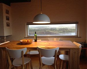 Dining area overlooking the dunes in The Helmhoeve vacation home, Midsland aan Zee on Terschelling.