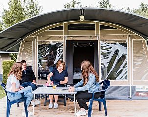 Enjoy a relaxing moment on the terrace at Camping Gritt Lodge in Ingeldorf, Luxembourg, with a view of the natural surroundings.
