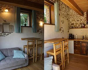 Gezellige binnenruimte van Vakantiehuisje in Espinasse, Auvergne, met rustieke stenen muren en houten interieur.