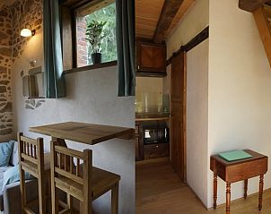 Gezellige binnenruimte van Vakantiehuisje in Espinasse, Auvergne, Frankrijk met rustieke houten meubels en stenen muren.