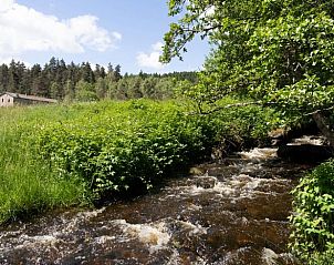 Vacation home in Saint Bonnet le Chastel in Auvergne, France, with beautiful views of a babbling brook and green nature.