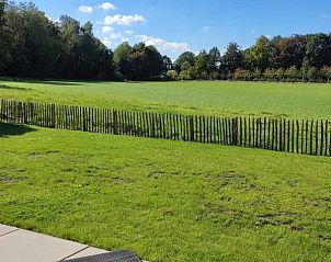 Ligstoelen met uitzicht op groene velden bij Moderne villa met zwembad en kinderboerderij in Affligem, Vlaams-Brabant.