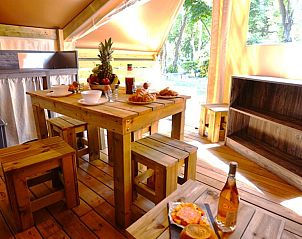 Enjoy a rustic dining experience at Tent Lodge Liberta, a glamping lodge in Moriani-Plage, Corsica, surrounded by nature.
