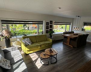 Lichte woonkamer van Chalet Sigal in Poppel, Antwerpen. Comfortabel interieur met uitzicht op de groene omgeving.