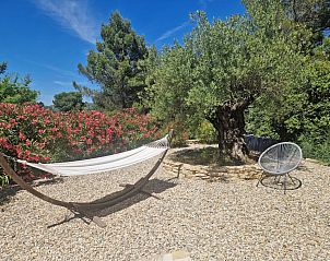 Relax in the hammock at La grande Pinde, a vacation home in the serene countryside of Faucon, Provence.