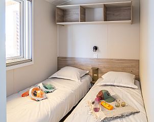 Cozy bedroom in a Premium Mobile Home in Martigues, Provence, featuring two beds and modern decor for a relaxing vacation.