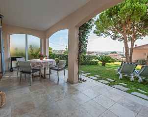 Enjoy the serene veranda of Azur by the Sea in Golfe-Juan, Provence, overlooking the lush garden and coastline.