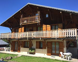 Cozy living room in vacation home Les Bouquetins, Crest-Voland, Rhone-Alphes, France with wooden furniture and attractive decoration.