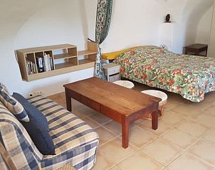 Cozy living room in Cottage in Saint-Maurice-d'Ibie, Rhone-Alphes, France with comfortable sofa and rustic table.