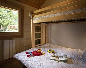 Cozy bedroom in Montana Chalet, Bourg Saint Maurice, Rhone-Alphes with bunk beds and views of nature.