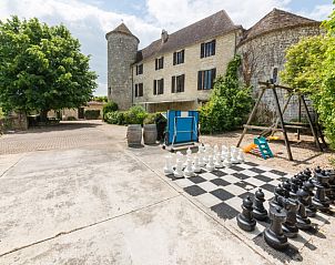 Chateau de Sadillac in Aquitaine, France, with a large chess set on the cottage terrace.