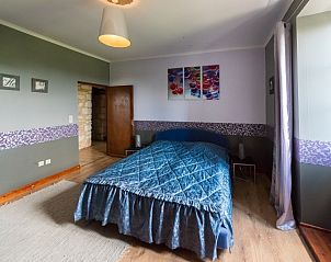 Cozy bedroom in Chateau de Sadillac, a vacation home in Sadillac, Aquitaine, France, with elegant decor and comfortable bed.