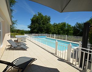 Enjoy the pool and sunny patio at La Roseraie, a vacation home in Terrasson-Lavilledieu, Aquitaine, France.