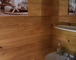 Cozy bathroom in Holiday Home in Bussang, Lorraine, France, with wood finishing for a warm atmosphere.