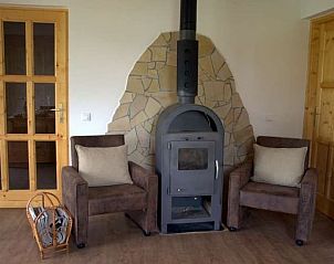 Cozy living room with wood stove in Holiday home in Tiszagyenda, Hungary, perfect for a relaxing stay in the Great Hungarian Lowlands.