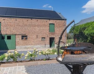 Cozy barbecue corner at cottage in Vonche, Ardennes, Belgium, surrounded by green nature and rustic charm.