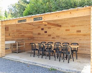 Covered outdoor space at cottage in Vonche, Ardennes, Belgium, ideal for meals in the fresh air.