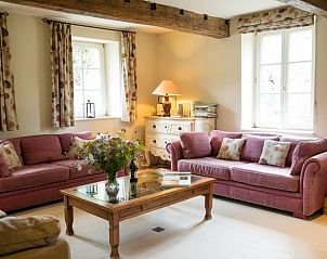 Cozy living room in Cottage in Yvoir, located in the Ardennes, Belgium. Comfortable sofas and country charm.