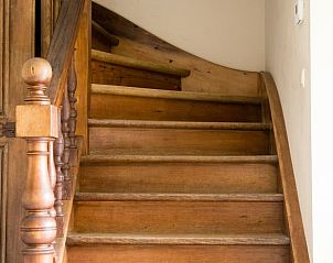 Wooden staircase in Holiday cottage in Yvoir, located in Ardennes, Belgium. Atmospheric interior of the cottage.