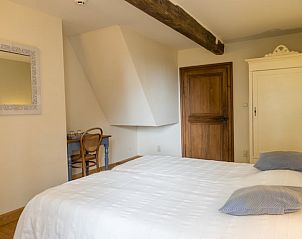 Cozy bedroom in Cottage in Yvoir, located in the Ardennes, Belgium. Enjoy rustic charm in this comfortable vacation home.
