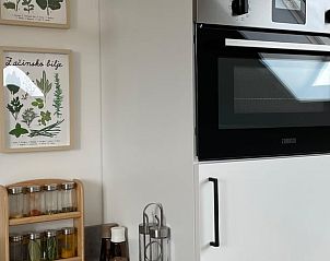 Modern kitchen of Cottage in Romedenne, vacation home in the Ardennes, Belgium, with spice rack and stylish oven.