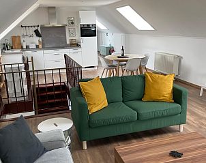Cozy living room in Cottage in Romedenne, a vacation home in Ardennes, Belgium with modern kitchen and dining area.