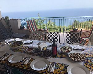 Enjoy a meal on the terrace of Casa Sirena overlooking the sea in Cefal, Sicily, vacation home in Italy.