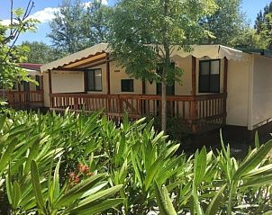 Toscachalets vacation home in Viareggio, Tuscany, surrounded by green nature with inviting veranda.