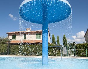 Refreshing pool with waterfall at Agriturismo Le Gorette in Cecina Mare, Tuscany, perfect for relaxation and fun.