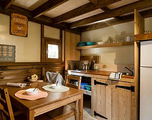 Cozy kitchen in Air Dreamer 3 glamping lodge, Cavriglia, Tuscany, with wooden interior and dining area.