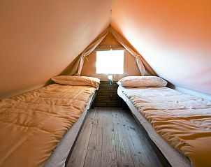 Cozy bedroom in Airstay tent house, Cavriglia, Tuscany with two comfortable beds.