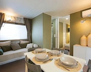 Cozy dining area in Cottage Next L Evo, a vacation home in Cavriglia, Tuscany, with modern furnishings and comfortable seating area.
